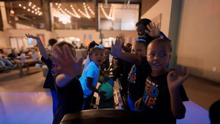 A group of children enjoying a game of bowling in a fun and lively atmosphere